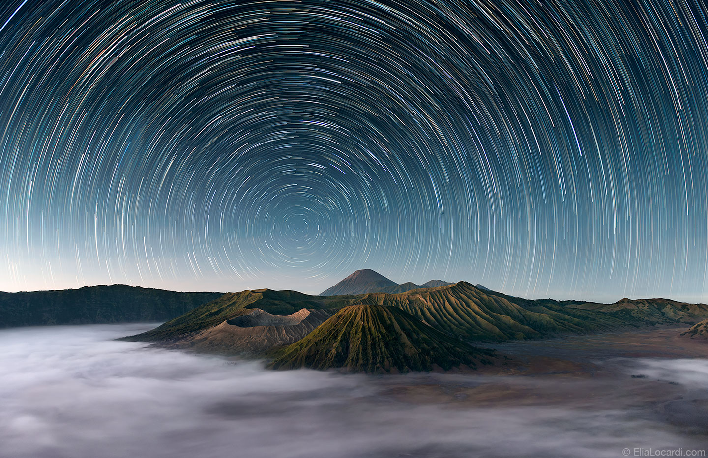 The stars dance above the extraordinary Mt Bromo Indonesia as the morning fog rolls through the caldera.